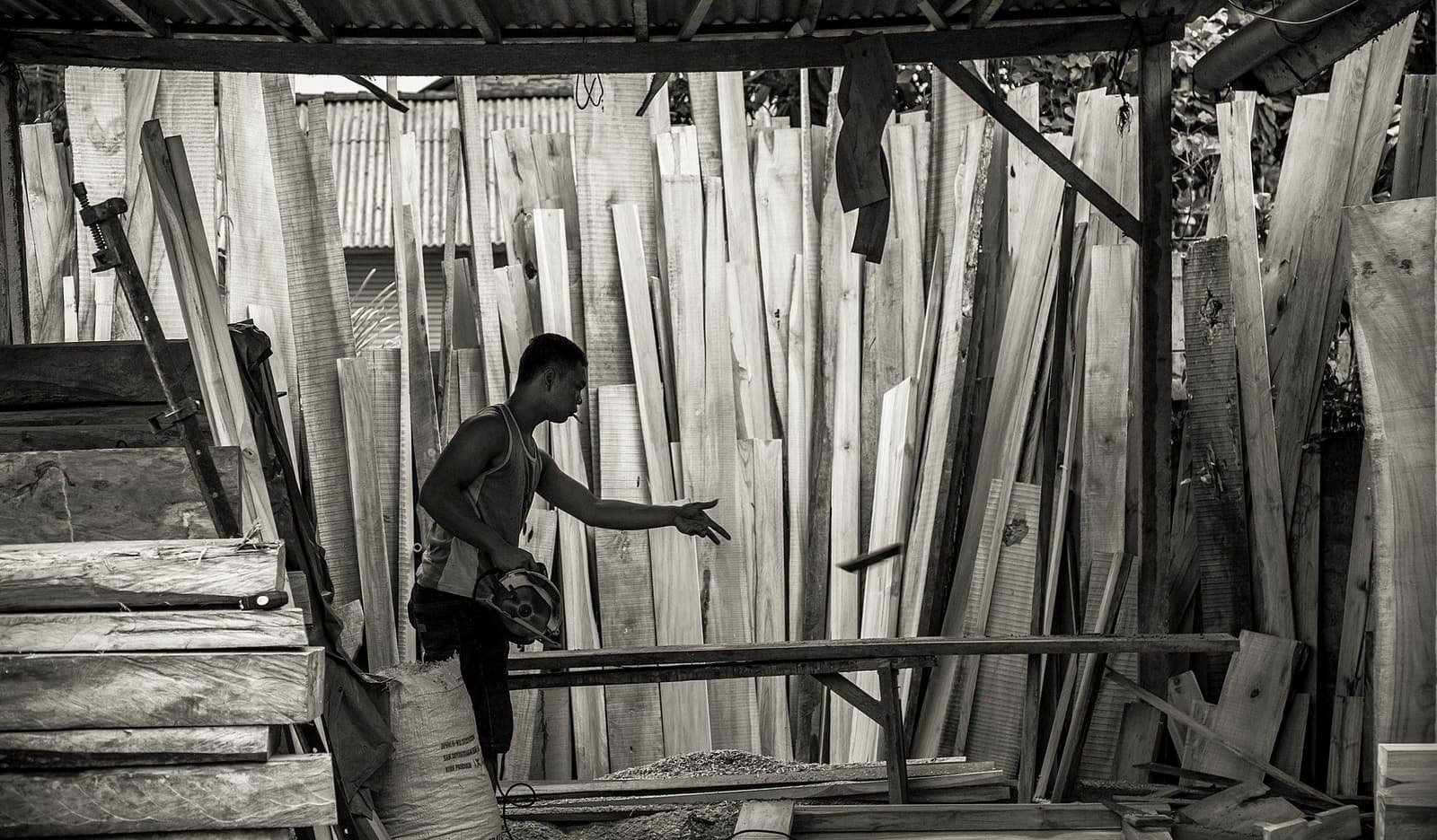 Carpenter working with timber at a workbench